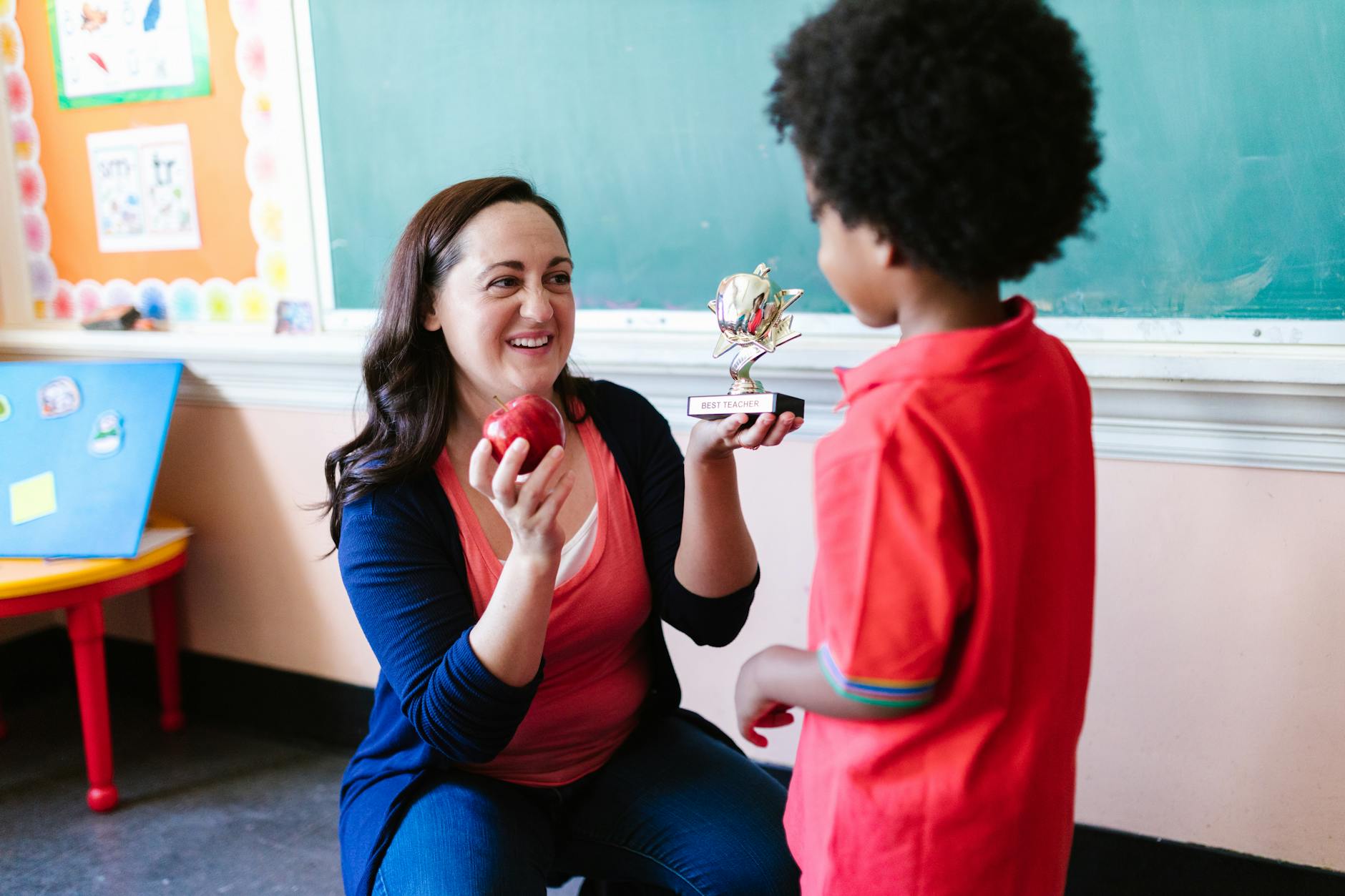 woman receiving best teacher prize from student