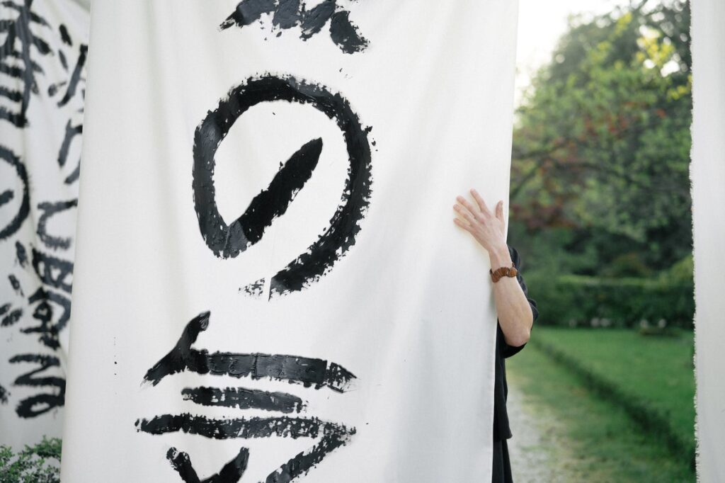 person holding white and black textile