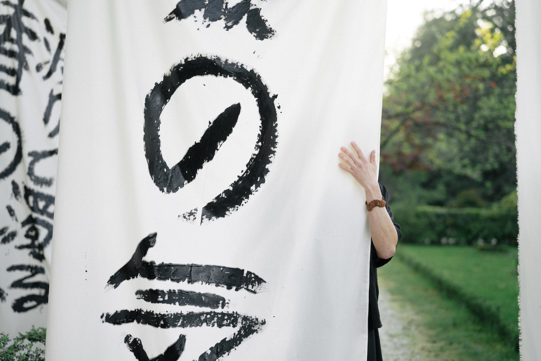 person holding white and black textile