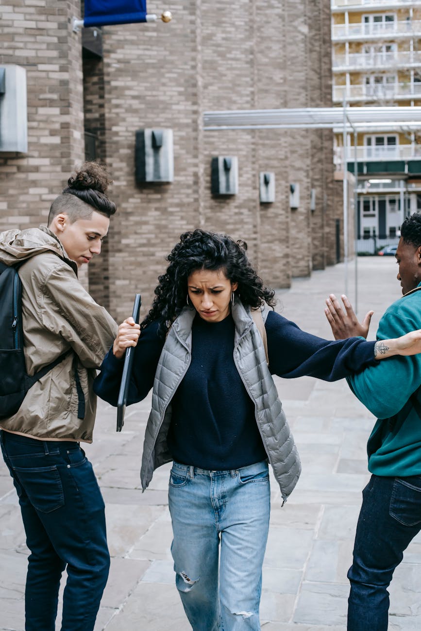 multiethnic students bullying classmate near university